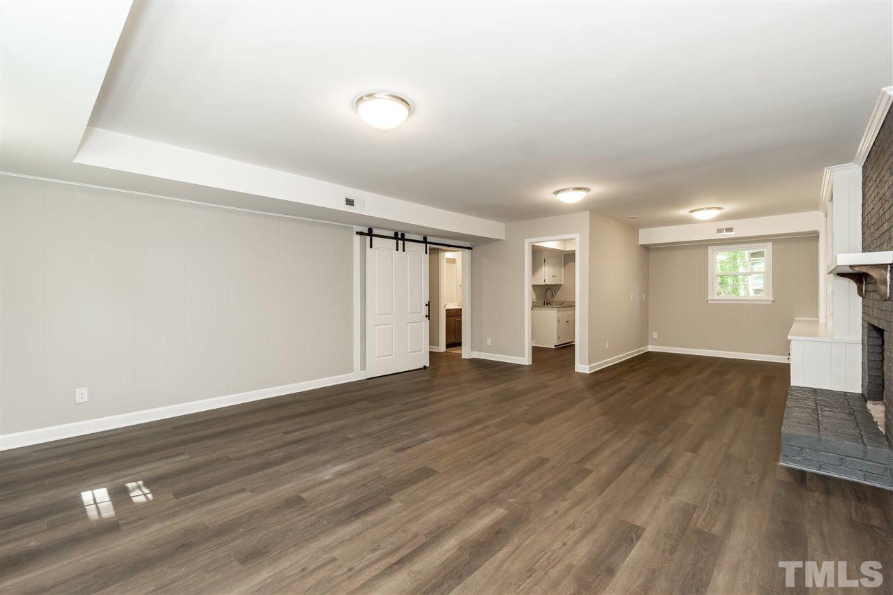 7204 Grist Mill Road Raleigh, NC 27615 - Photo 21 of 30 a view of an empty room with wooden floor and a window