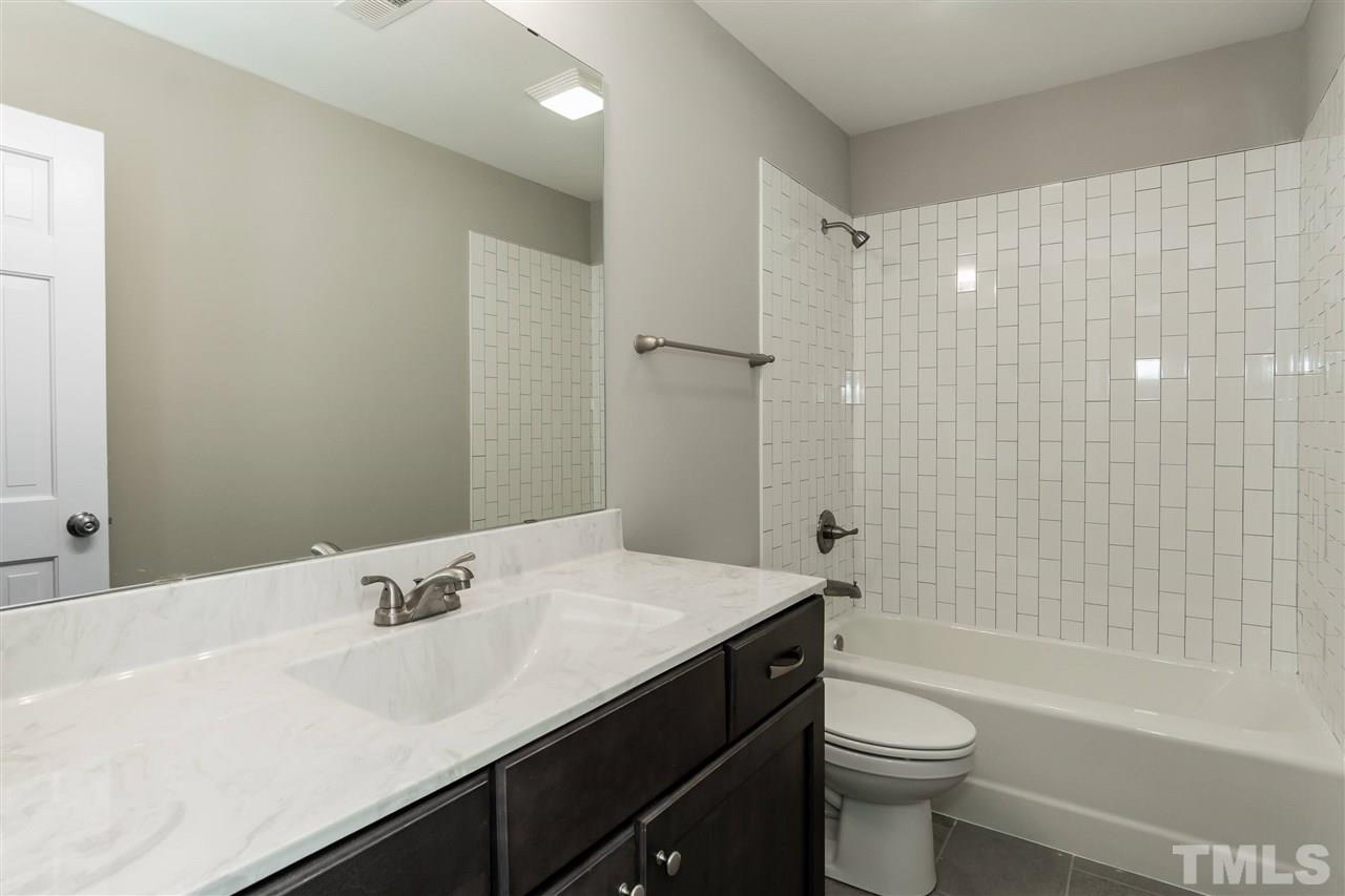 7204 Grist Mill Road Raleigh, NC 27615 - Photo 23 of 30 a bathroom with a sink a toilet and shower