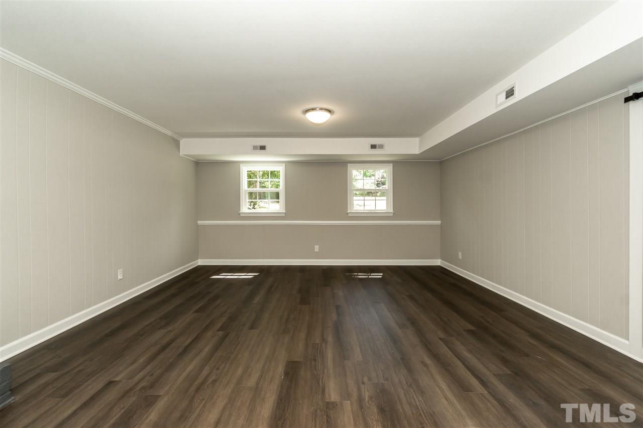 7204 Grist Mill Road Raleigh, NC 27615 - Photo 24 of 30 an empty room with wooden floor and windows