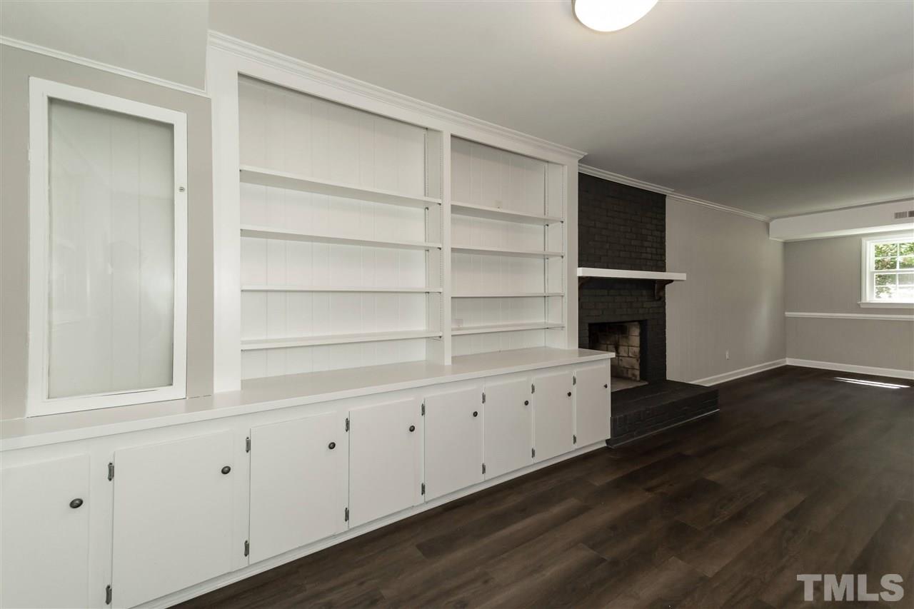 7204 Grist Mill Road Raleigh, NC 27615 - Photo 25 of 30 a view of an empty room with wooden floor and cabinet