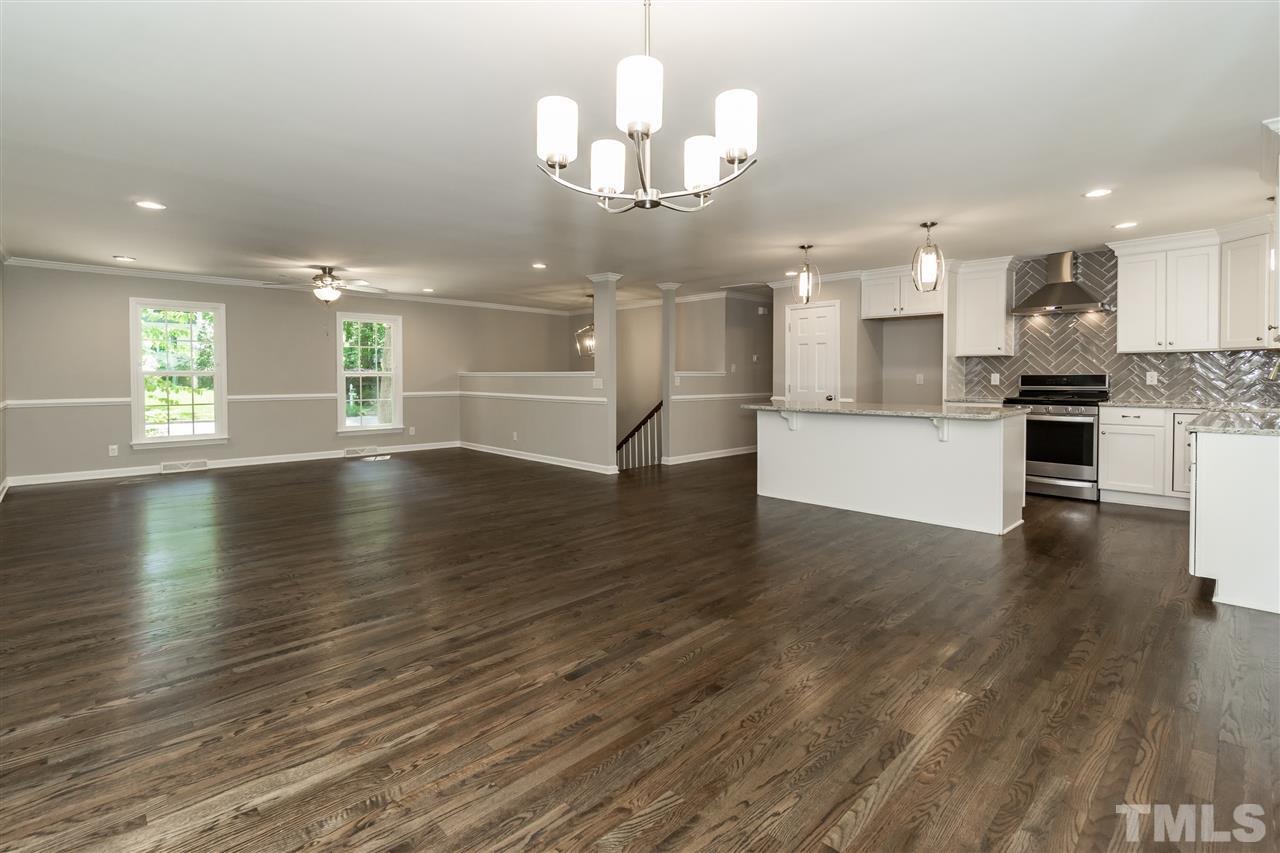 7204 Grist Mill Road Raleigh, NC 27615 - Photo 5 of 30 a view of a kitchen with granite countertop a stove top oven a sink and a wooden floors