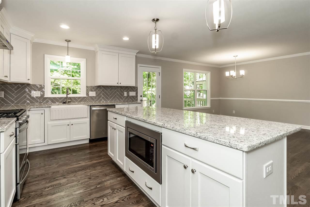 7204 Grist Mill Road Raleigh, NC 27615 - Photo 6 of 30 a kitchen with granite countertop white cabinets and white appliances