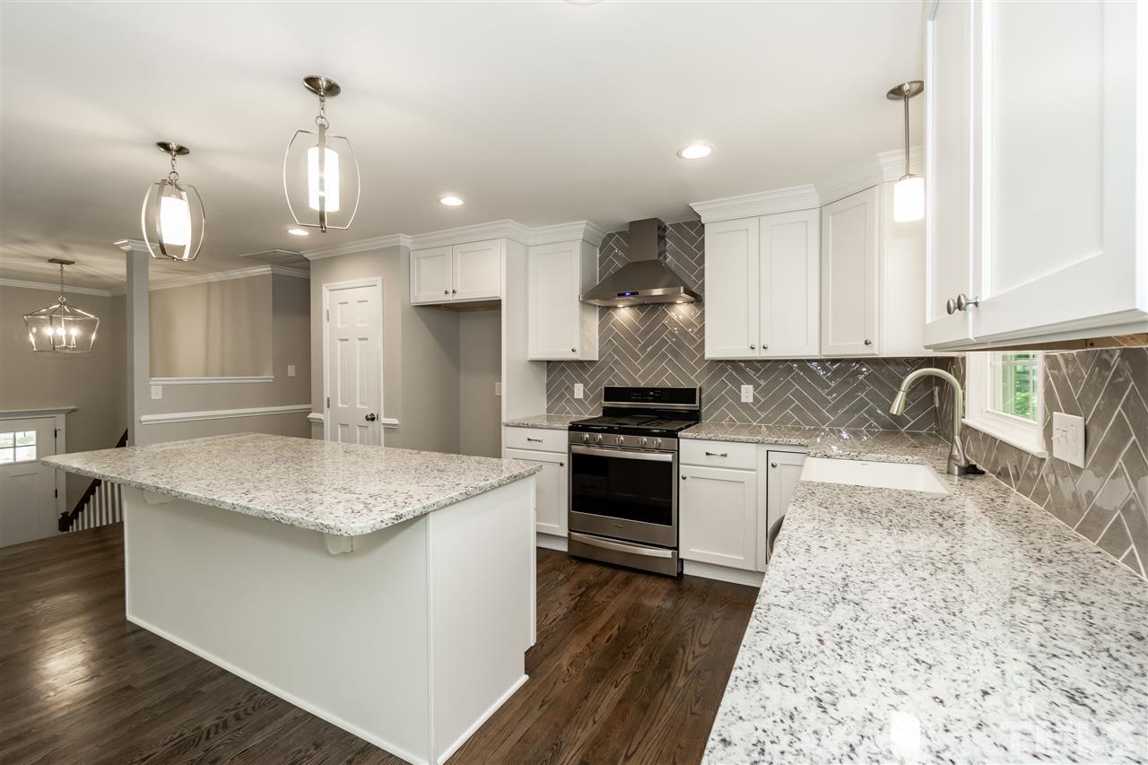 7204 Grist Mill Road Raleigh, NC 27615 - Photo 7 of 30 a kitchen with a sink stove and refrigerator