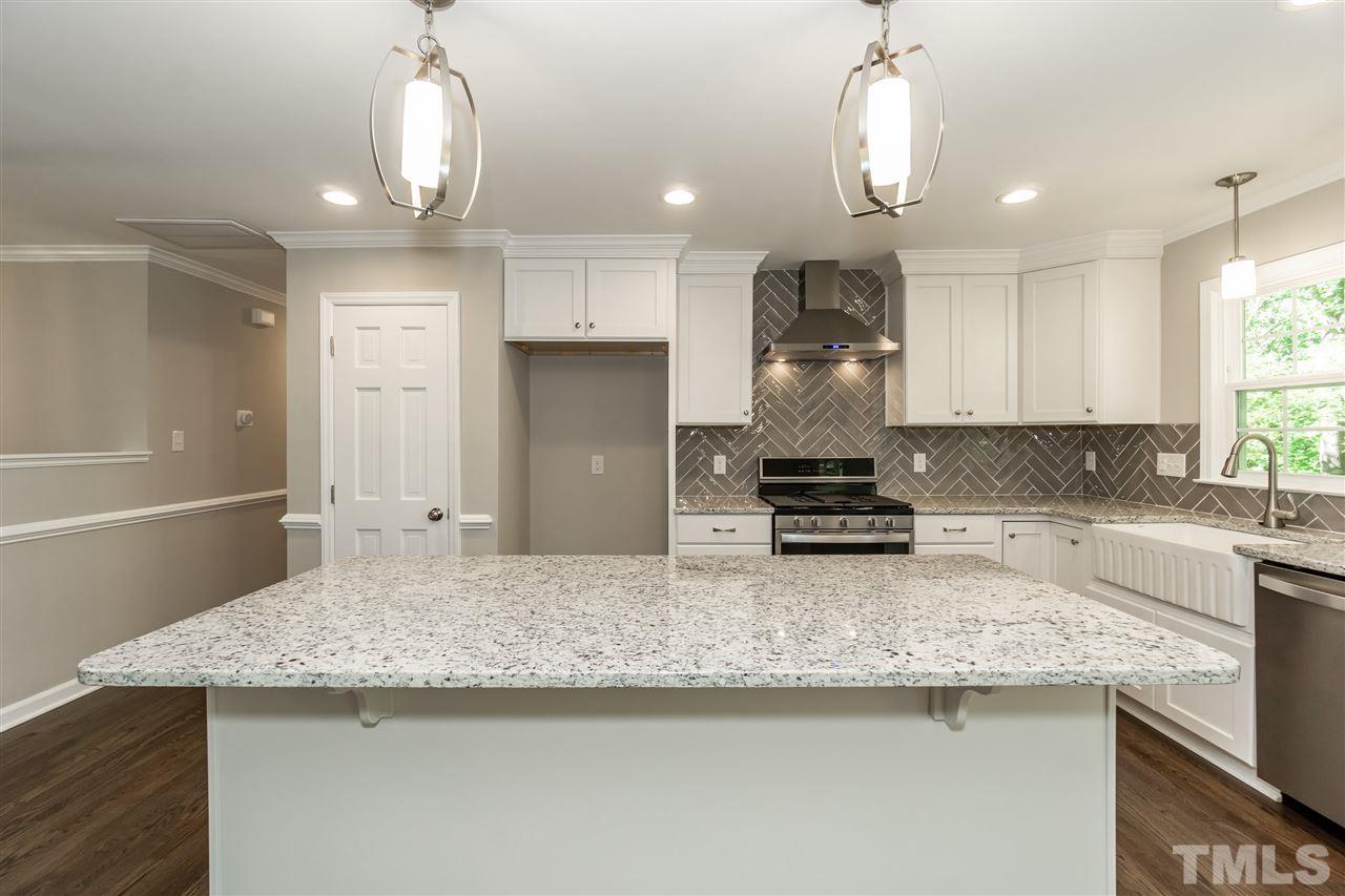 7204 Grist Mill Road Raleigh, NC 27615 - Photo 8 of 30 a kitchen with granite countertop cabinets and refrigerator