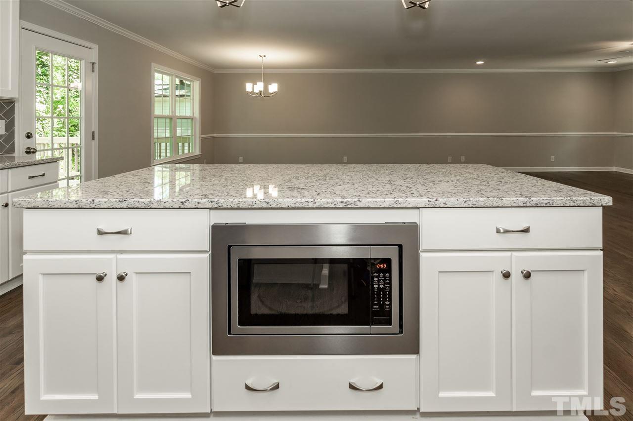 7204 Grist Mill Road Raleigh, NC 27615 - Photo 9 of 30 a bathroom with granite countertop white cabinets and white appliances