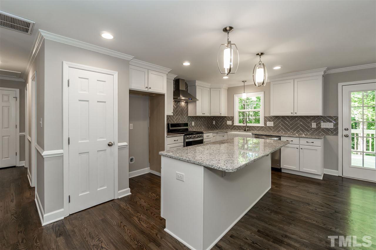 7204 Grist Mill Road Raleigh, NC 27615 - Photo 10 of 30 a kitchen with a refrigerator a sink and cabinets