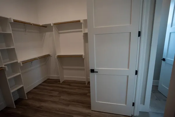 a view of walk in closet with empty racks