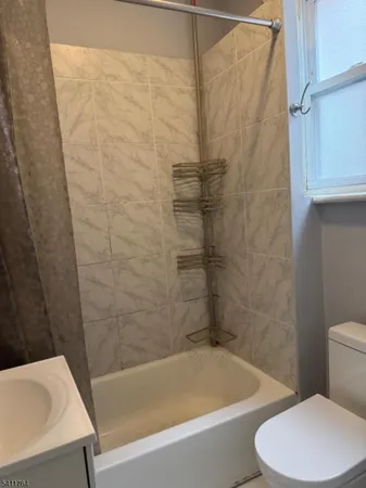 a bathroom with a toilet and a bathtub