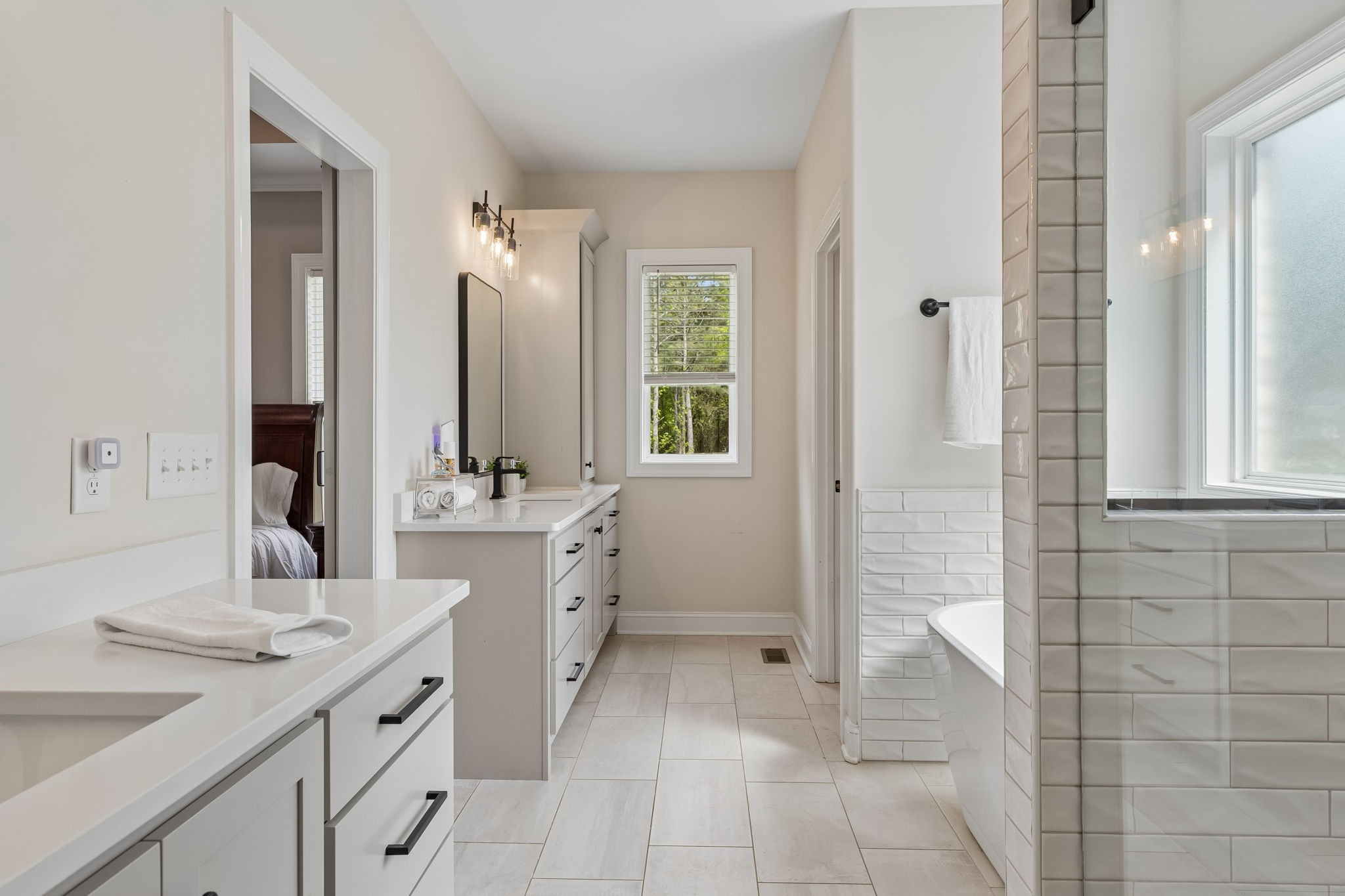 8708 Newtown Road Rockvale, TN 37153 - Photo 23 of 50 a bathroom with a double vanity sink a mirror and a bathtub