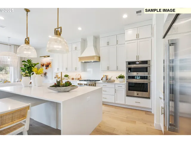 a kitchen with kitchen island a stove a sink and a refrigerator