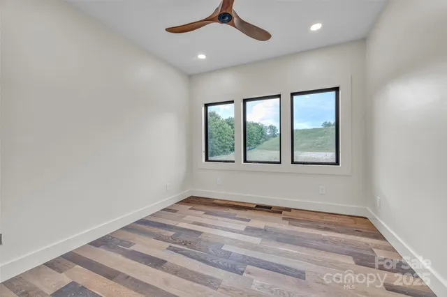 an empty room with a empty space and windows