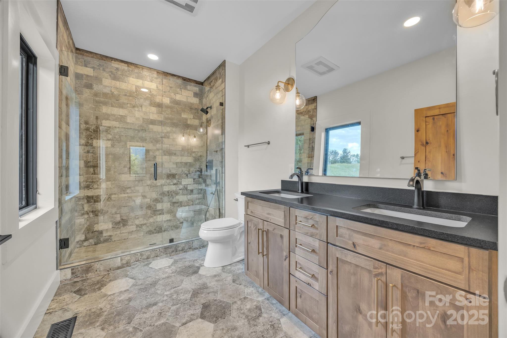 Tbd Range View Drive Jefferson, NC 28640 - Photo 30 of 46 a bathroom with a granite countertop sink a toilet a mirror and shower
