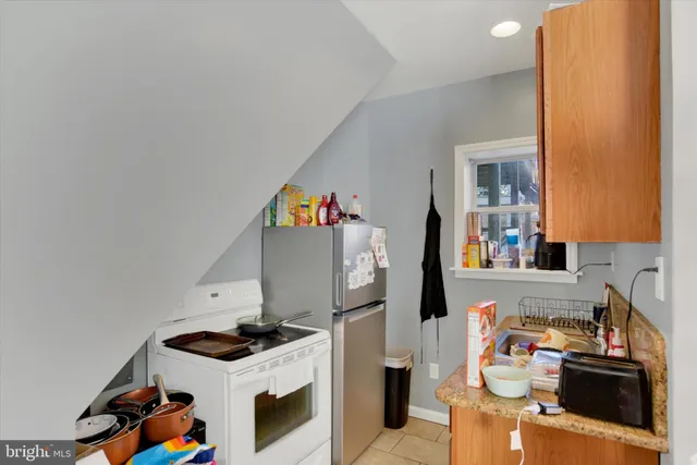 a kitchen with stainless steel appliances granite countertop a stove and a refrigerator