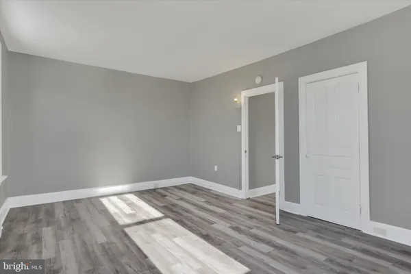 a view of room with wooden floor