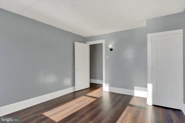 an empty room with wooden floor