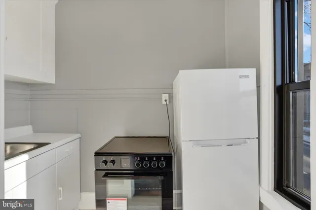 a view of a kitchen with refrigerator and stove
