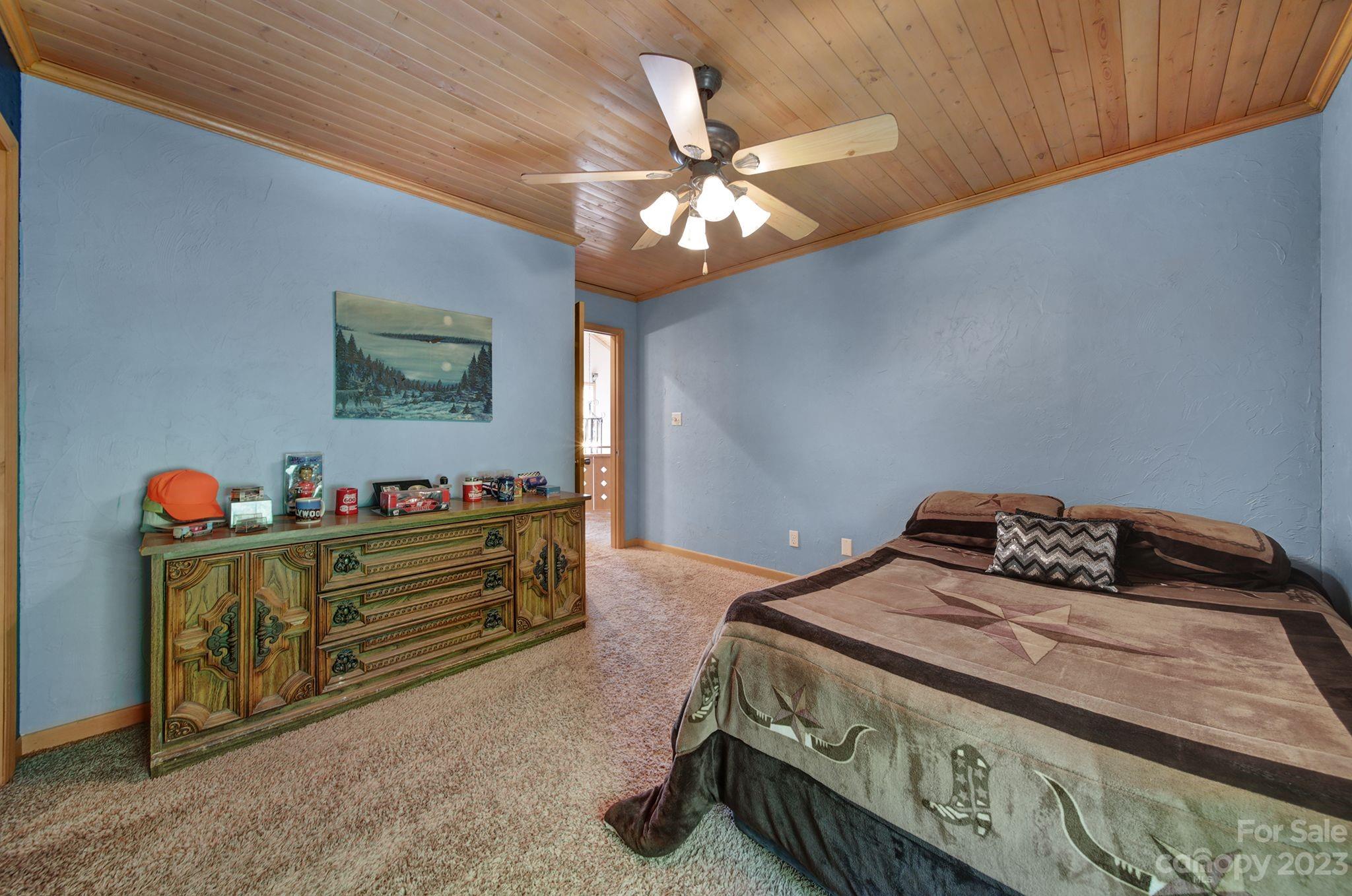332 Boggs Road Thomasville, NC 27360 - Photo 17 of 41 a bedroom with a bed and a chandelier