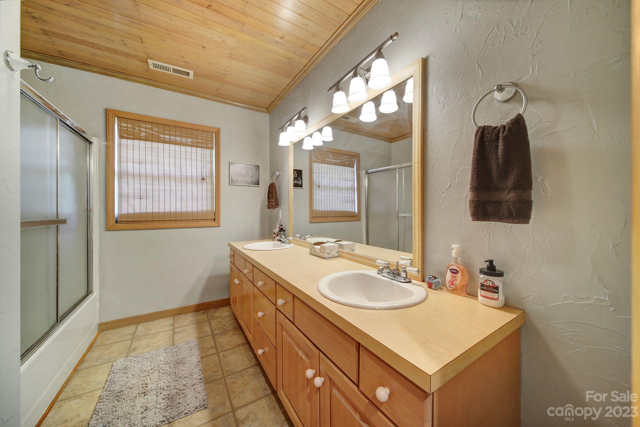 332 Boggs Road Thomasville, NC 27360 - Photo 20 of 41 a bathroom with a sink double vanity and a mirror