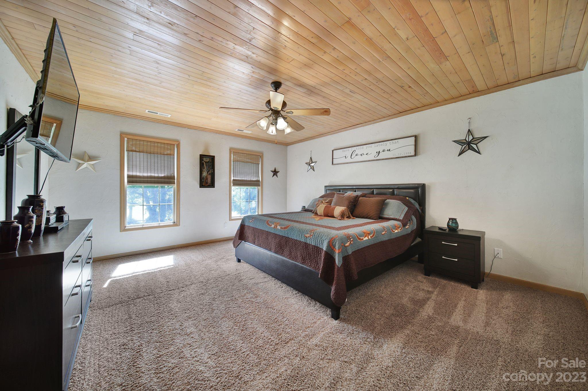 332 Boggs Road Thomasville, NC 27360 - Photo 21 of 41 a spacious bedroom with a bed and a chandelier