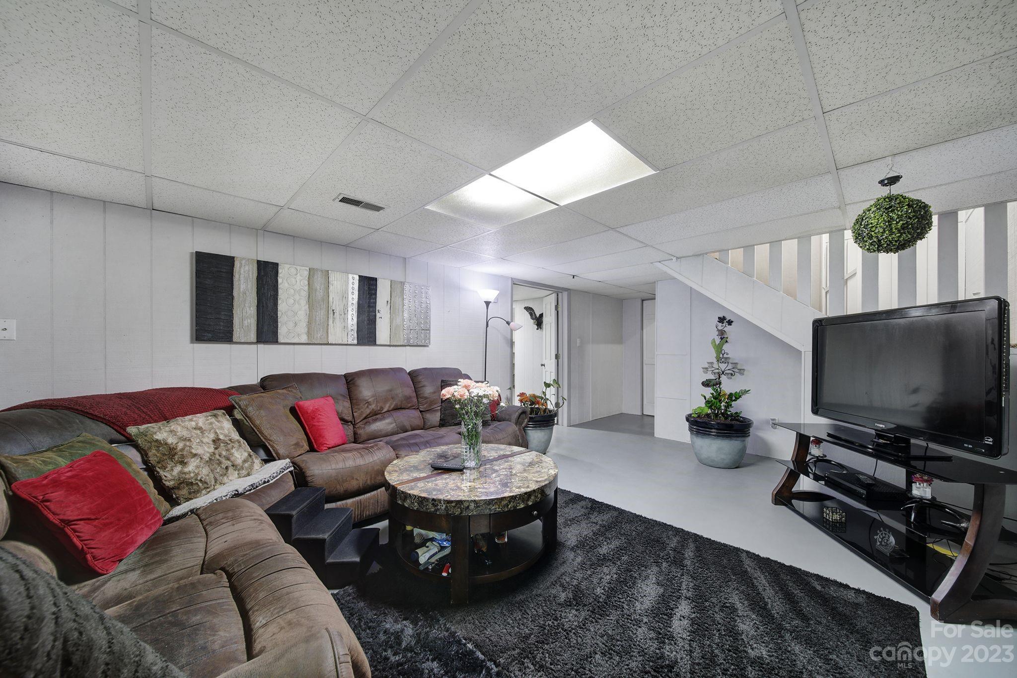 332 Boggs Road Thomasville, NC 27360 - Photo 27 of 41 a living room with furniture and a flat screen tv