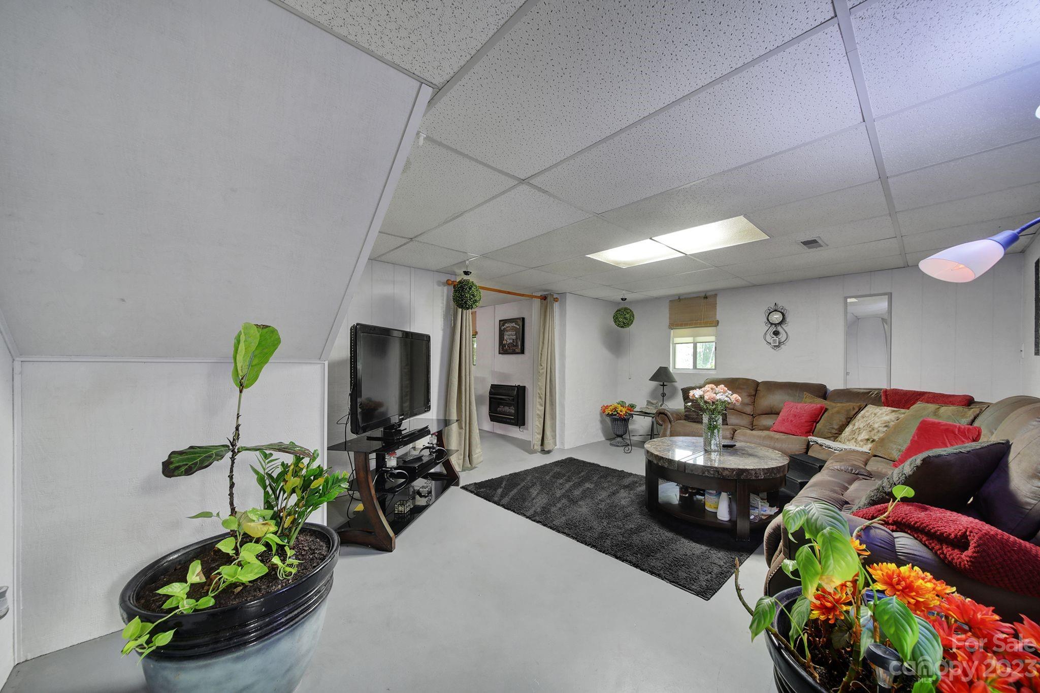 332 Boggs Road Thomasville, NC 27360 - Photo 28 of 41 a living room with furniture and a flat screen tv