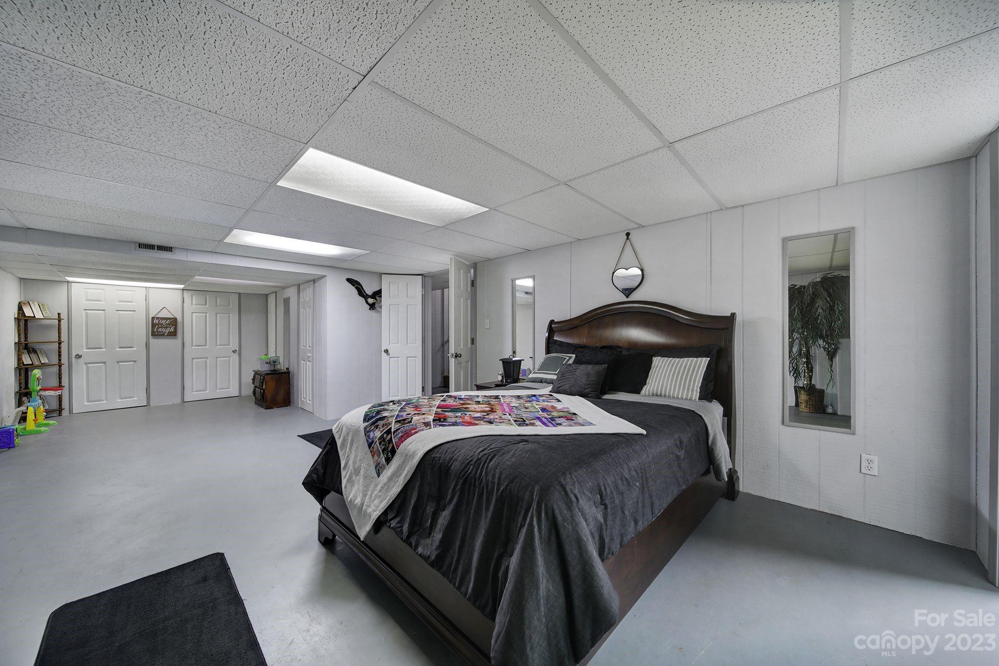 332 Boggs Road Thomasville, NC 27360 - Photo 31 of 41 a bedroom with a bed and a chandelier