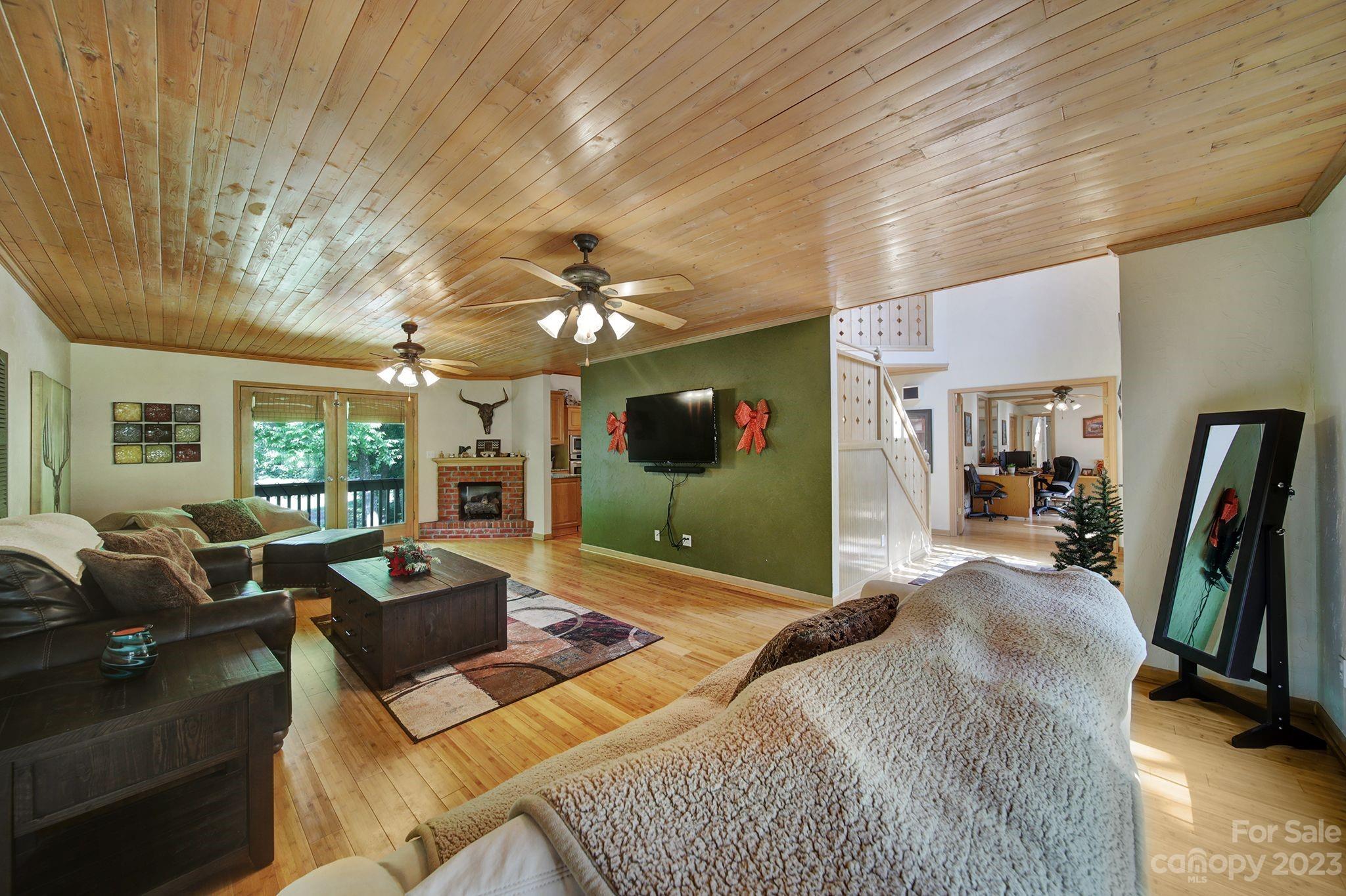 332 Boggs Road Thomasville, NC 27360 - Photo 4 of 41 a living room with furniture a flat screen tv and a chandelier