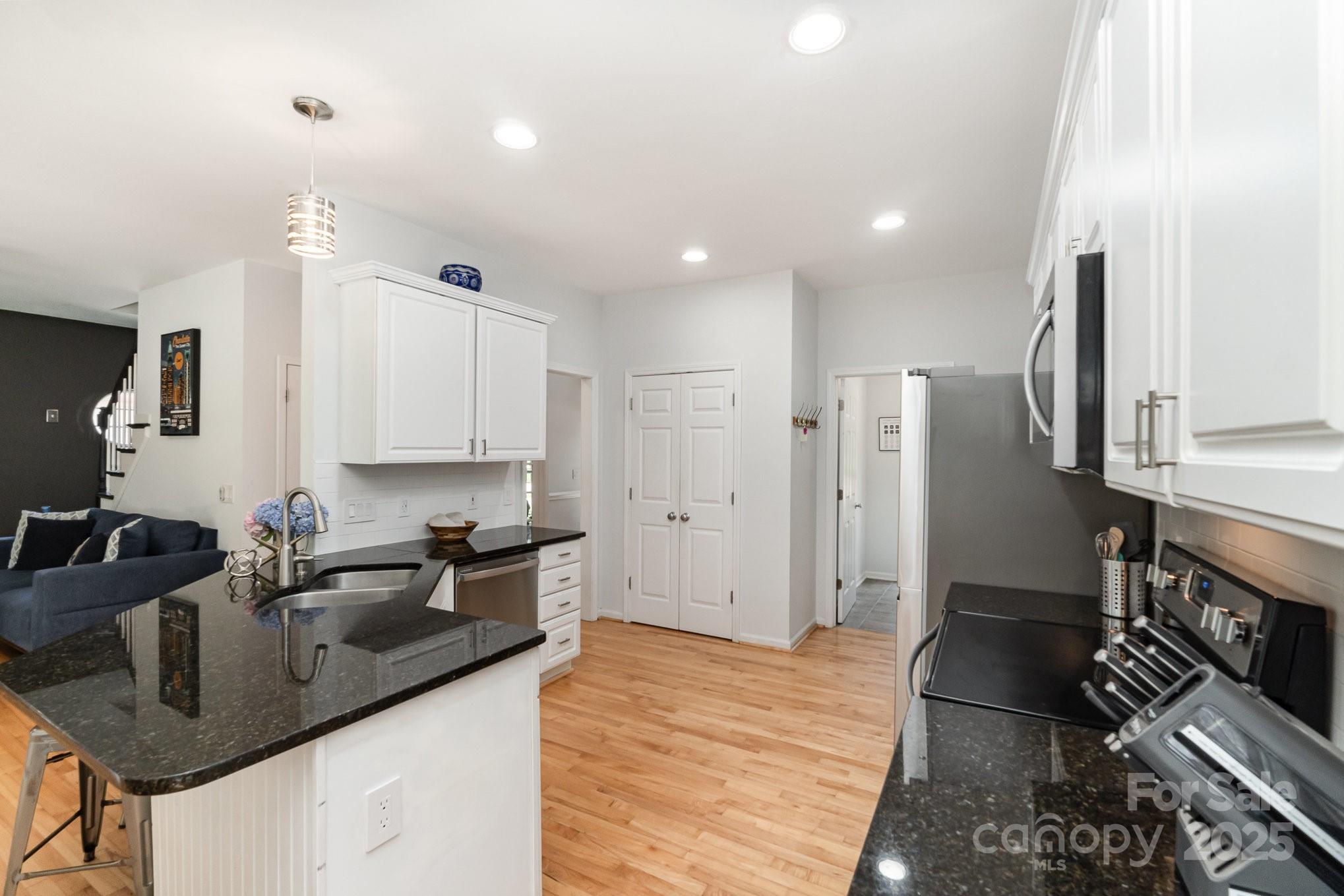 11624 Crossroads Place Concord, NC 28025 - Photo 13 of 45 a kitchen with stainless steel appliances granite countertop a sink refrigerator and cabinets
