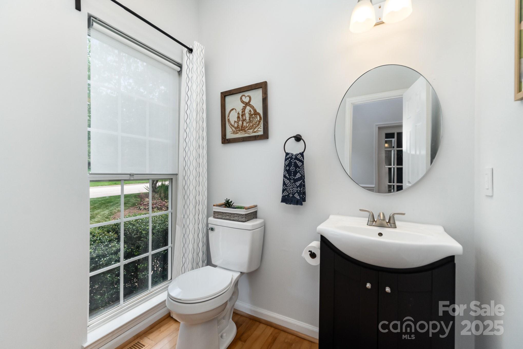 11624 Crossroads Place Concord, NC 28025 - Photo 17 of 45 a bathroom with a toilet sink and mirror