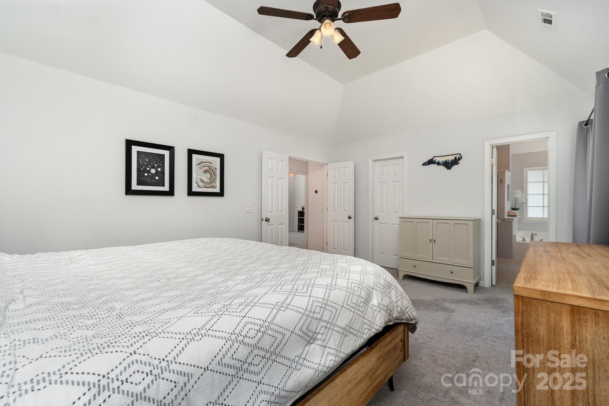 11624 Crossroads Place Concord, NC 28025 - Photo 21 of 45 a bedroom with a bed and a chandelier