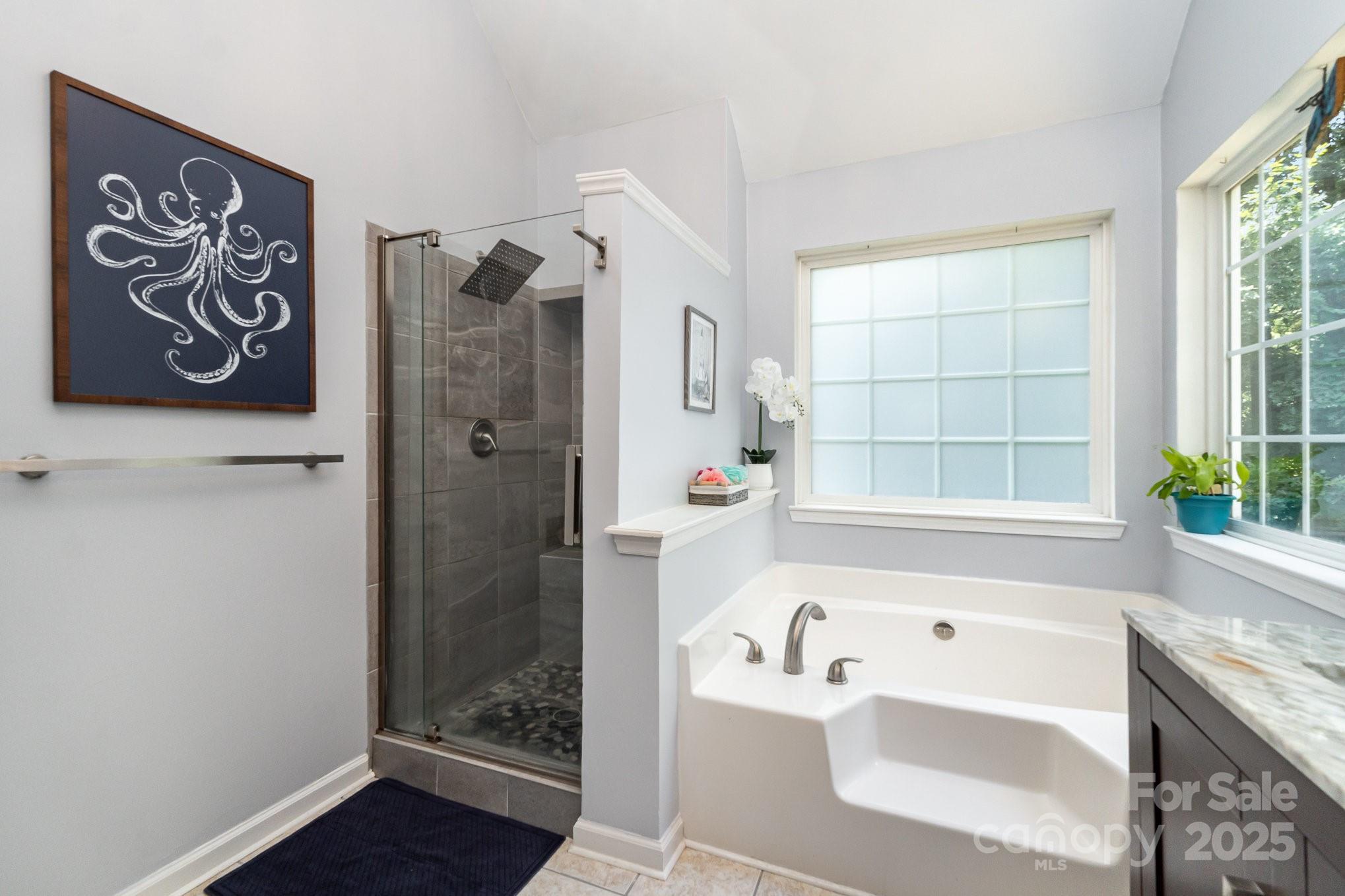 11624 Crossroads Place Concord, NC 28025 - Photo 22 of 45 a bathroom with a bathtub and a shower
