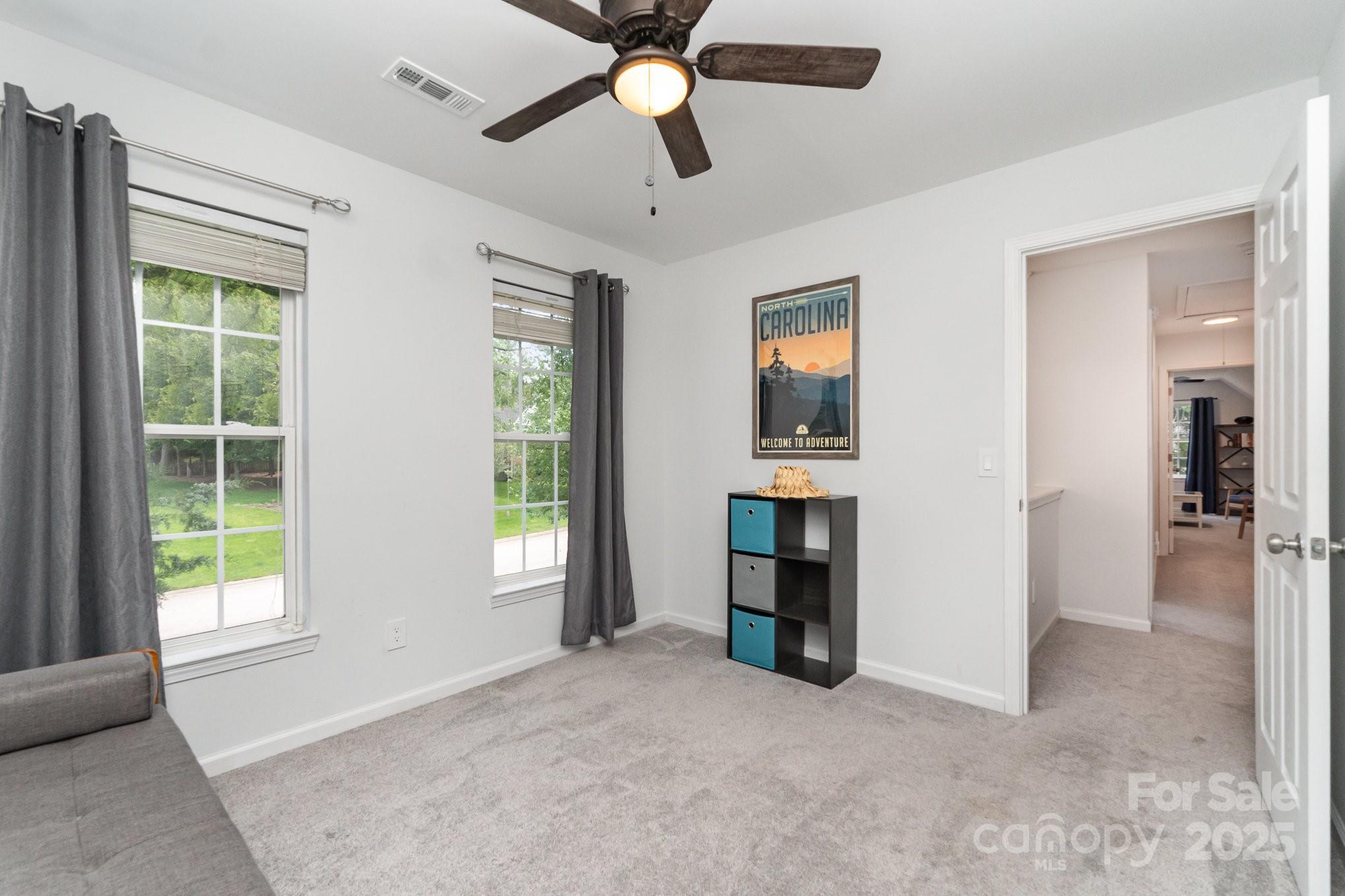 11624 Crossroads Place Concord, NC 28025 - Photo 24 of 45 an empty room with windows and cabinet