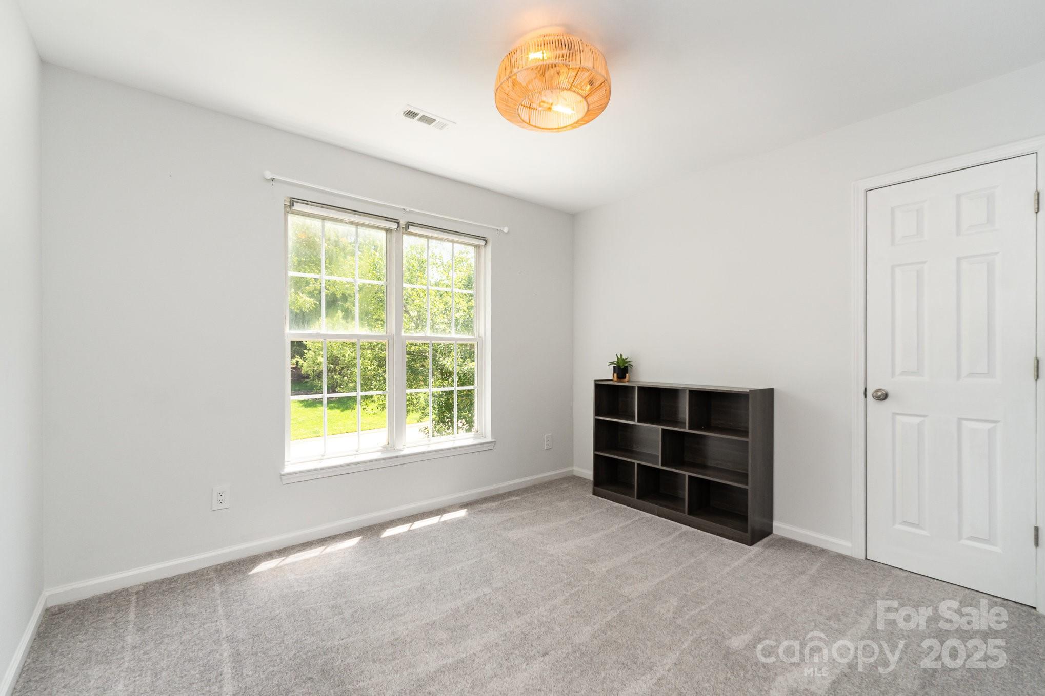 11624 Crossroads Place Concord, NC 28025 - Photo 26 of 45 an empty room with windows and closet