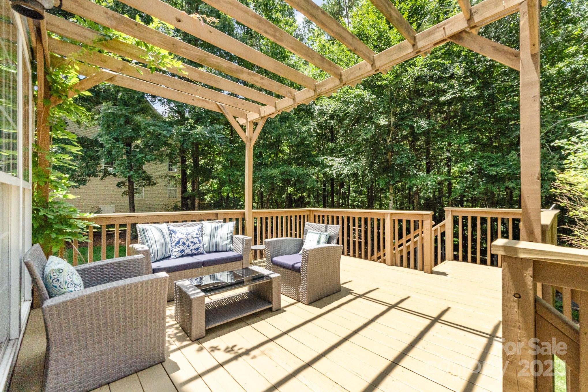 11624 Crossroads Place Concord, NC 28025 - Photo 32 of 45 a roof deck with couches and wooden fence