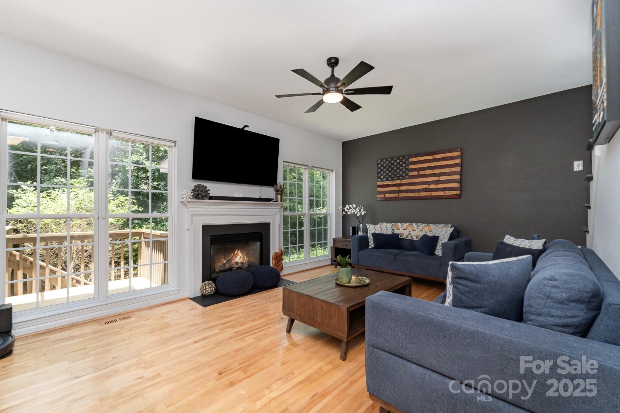 11624 Crossroads Place Concord, NC 28025 - Photo 8 of 45 a living room with furniture a fireplace and a flat screen tv