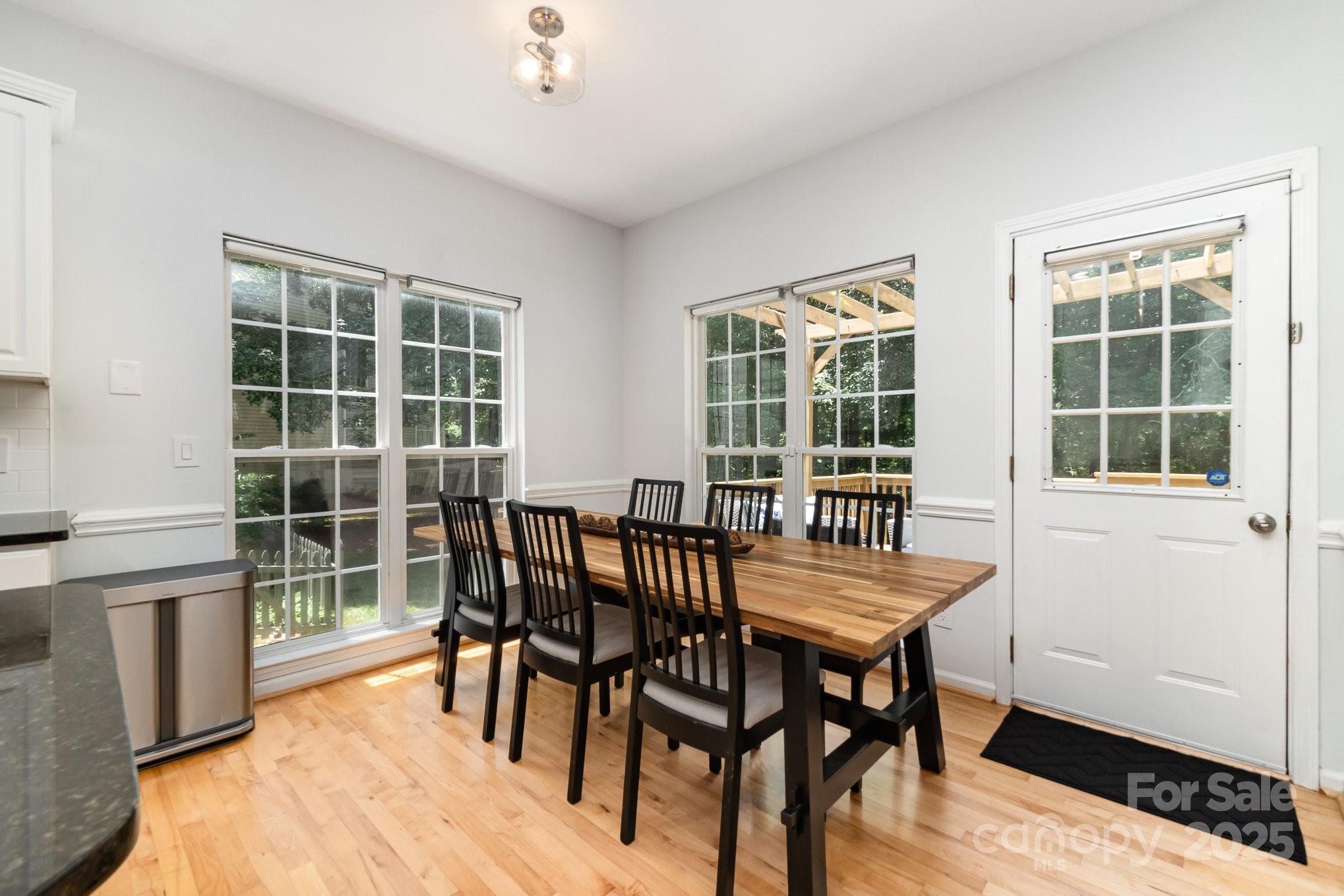 11624 Crossroads Place Concord, NC 28025 - Photo 9 of 45 a view of a dining room with furniture window and wooden floor