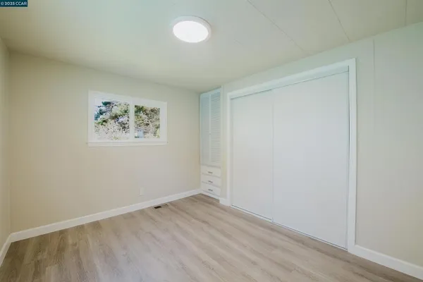 an empty room with a door and wooden floor