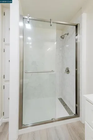 a bathroom with a glass shower door
