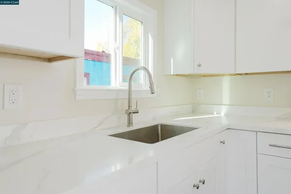 a kitchen with a sink and cabinets
