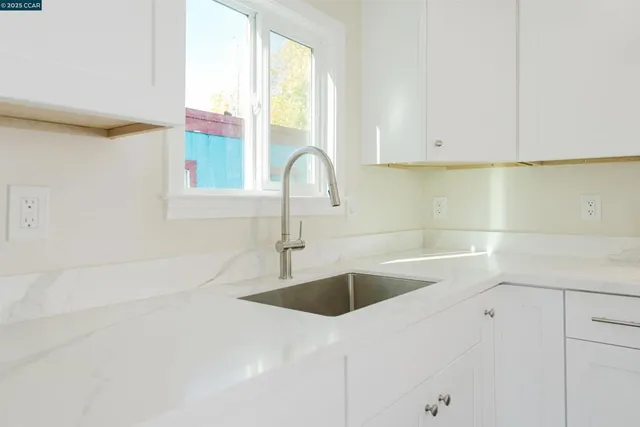 a kitchen with a sink and cabinets