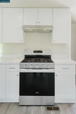 a stove top oven sitting inside of a kitchen