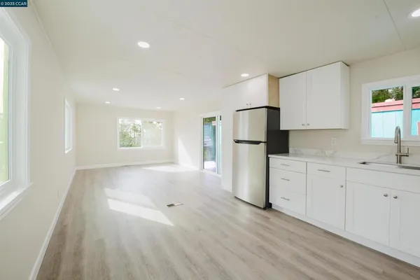 a view of a kitchen with a sink dishwasher and a refrigerator
