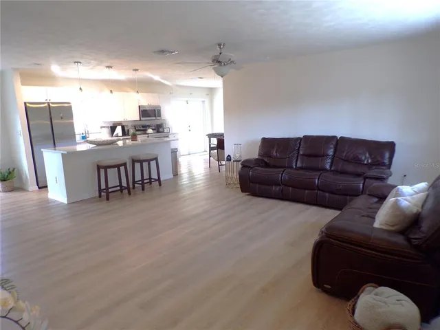 a living room with furniture and kitchen view