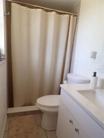 a white toilet sitting next to a bathroom sink