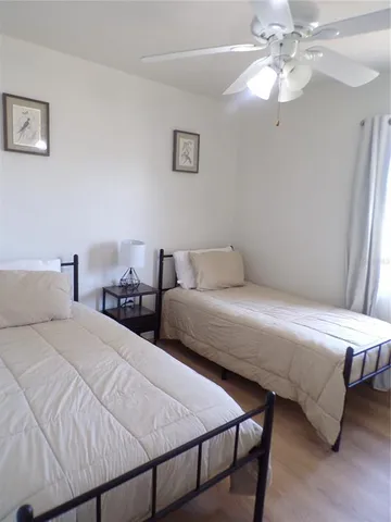 a bedroom with two beds and a chandelier