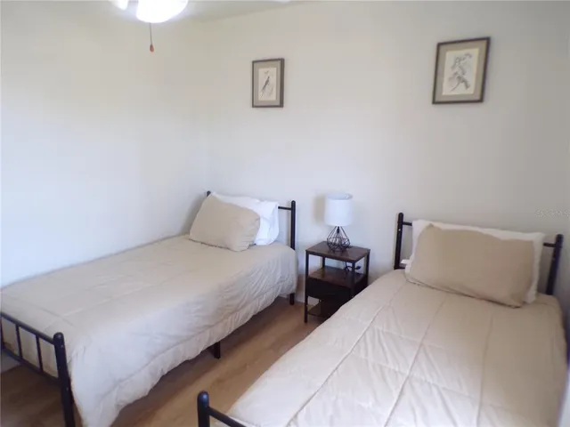 a bedroom with bed and a night stand