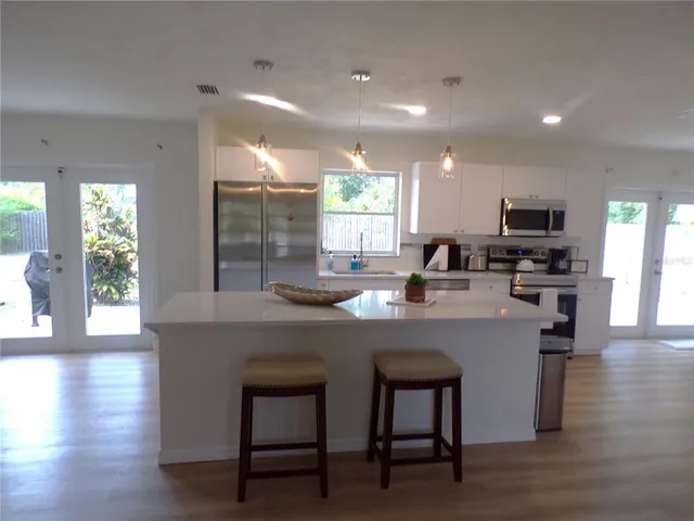 a kitchen with counter space and dining table