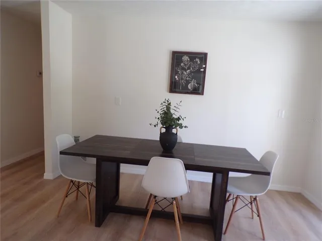 a dining room with furniture and wooden floor