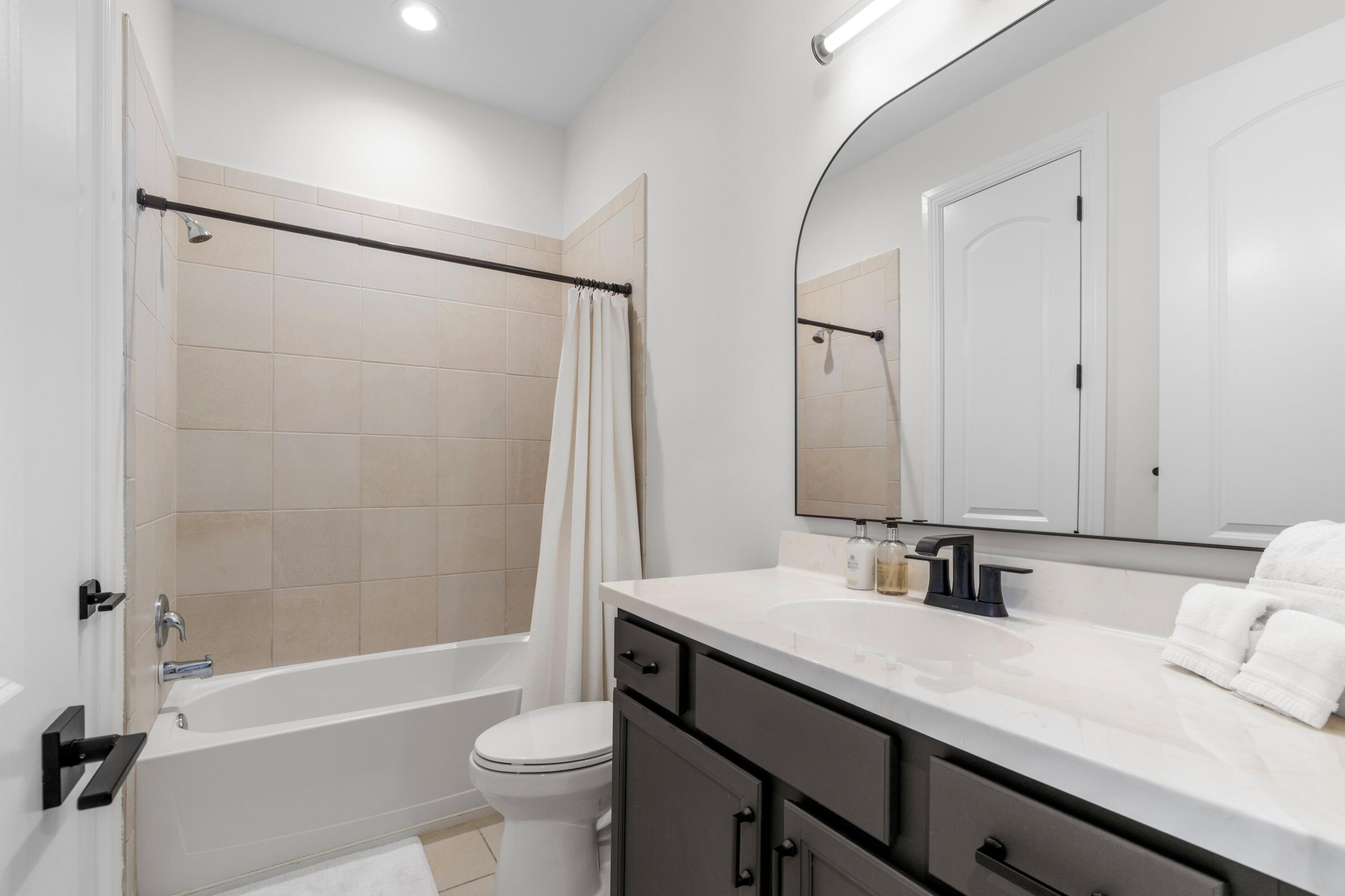 100 Northwest 69th Circle, Unit 82 Boca Raton, FL 33487 - Photo 17 of 42 a bathroom with a bathtub shower sink vanity and toilet