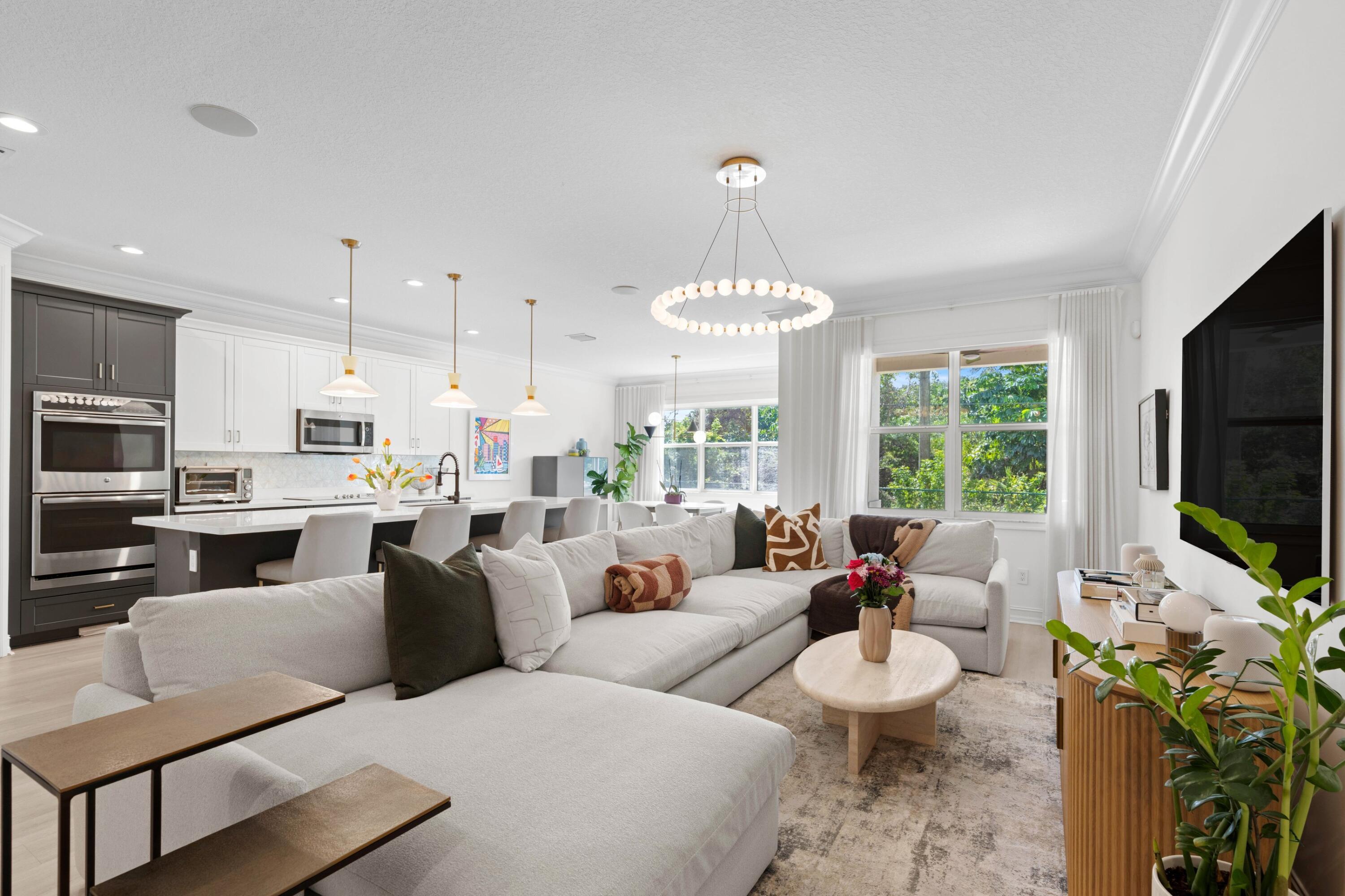100 Northwest 69th Circle, Unit 82 Boca Raton, FL 33487 - Photo 4 of 42 a living room with furniture a flat screen tv and a chandelier